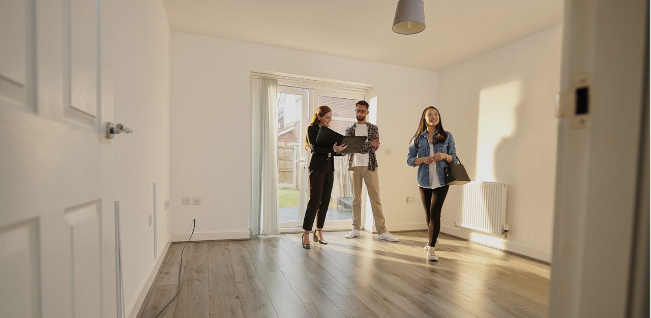 Image of three people in an empty property representing sub-let plus