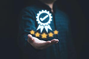 Man holding 5 stars and a rosette.