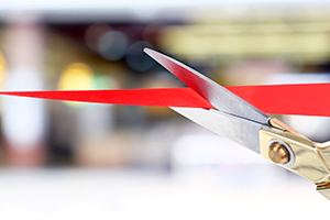 scissors cutting red tape