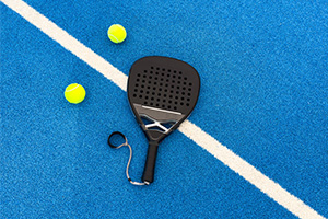padel racket and balls on a court