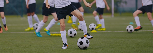 lots of children playing with individual footballs